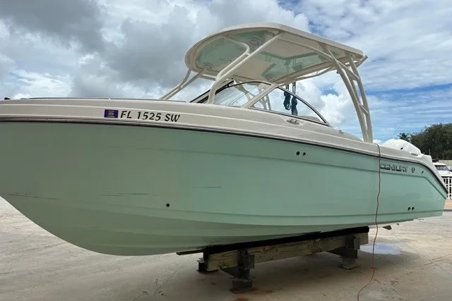 Slide: The Image of 2021 Century 24 Resorter boat on a stand, light blue hull, cloudy sky background. - 23
