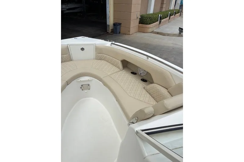 Slide: The Image of 2021 Century 24 Resorter boat interior with beige quilted seating and cup holders. - 32