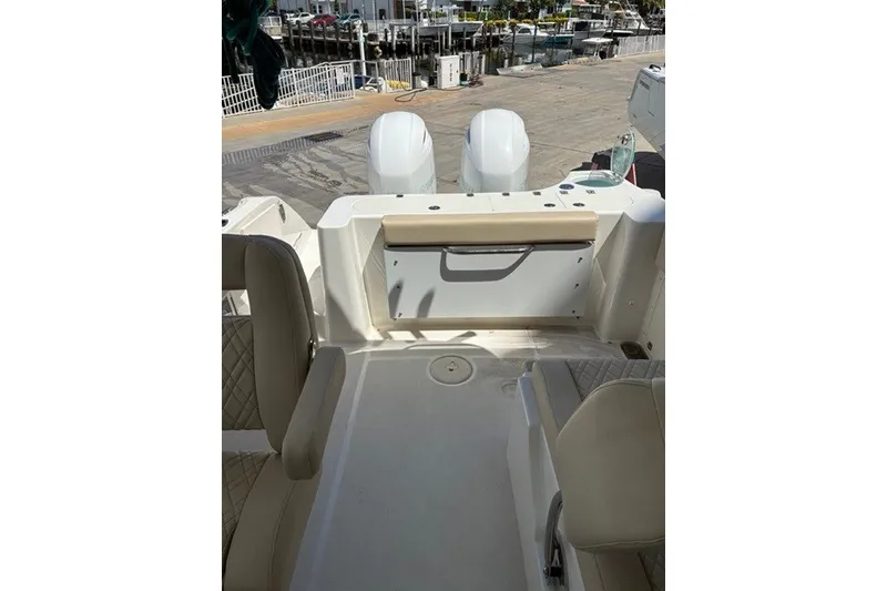 Slide: The Image of 2021 Century 24 Resorter boat interior with seating and dual engines at dock. - 40