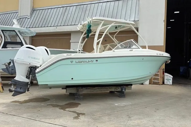 Slide: The Image of 2021 Century 24 Resorter boat with Yamaha engine, displayed outdoors on a stand. - 19