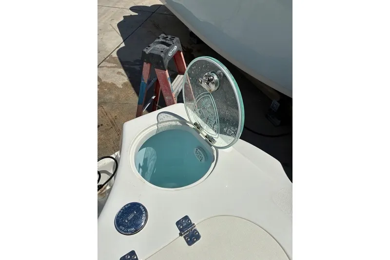 Slide: The Image of Open hatch on 2021 Century 24 Resorter boat, revealing a water-filled compartment. - 49