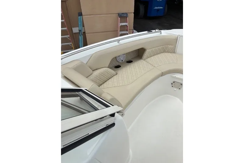 Slide: The Image of 2021 Century 24 Resorter boat interior with beige cushioned seating and cup holders. - 31