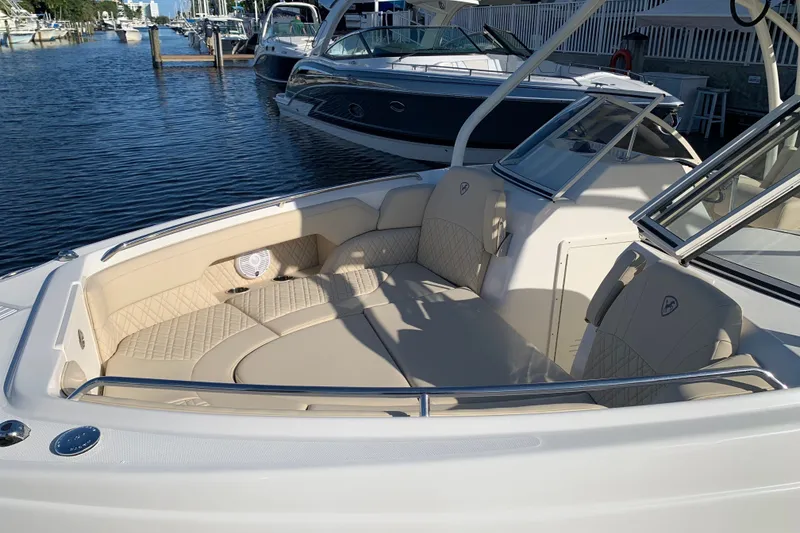 Slide: The Image of 2021 Century 24 Resorter boat with beige seating, docked at a marina. - 17