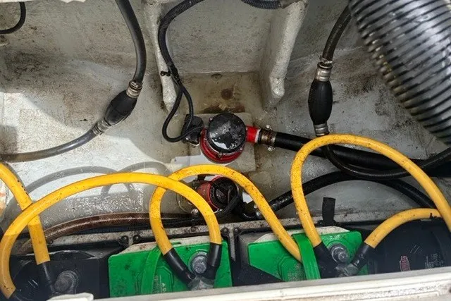 Slide: The Image of Engine compartment of a 2021 Century 24 Resorter boat with visible wiring and components. - 51