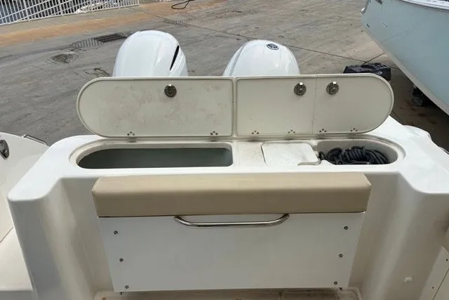Slide: The Image of 2021 Century 24 Resorter boat with dual outboard motors and storage compartments. - 48