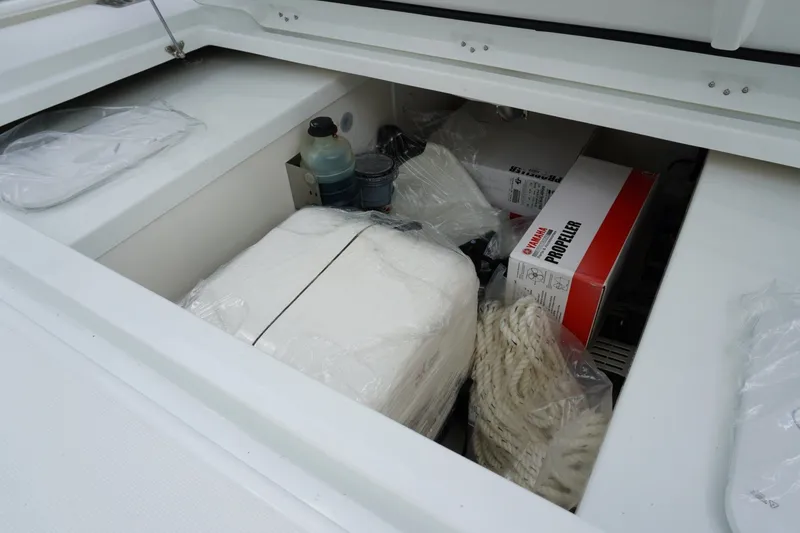 Slide: The Image of Storage compartment of 2027 Jeanneau Leader 10.5 WA Series 2 with boating supplies. - 12