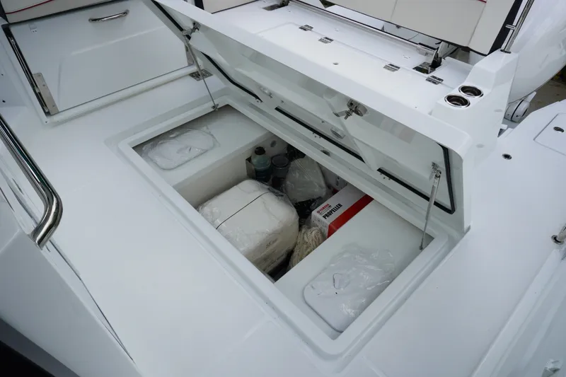 Slide: The Image of Storage compartment on 2027 Jeanneau Leader 10.5 WA Series 2 boat, open with supplies inside. - 11