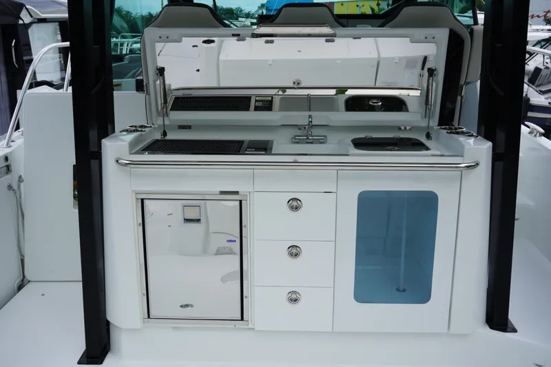 Slide: The Image of Outdoor kitchen on 2027 Jeanneau Leader 10.5 WA Series 2 boat, featuring grill and sink. - 14
