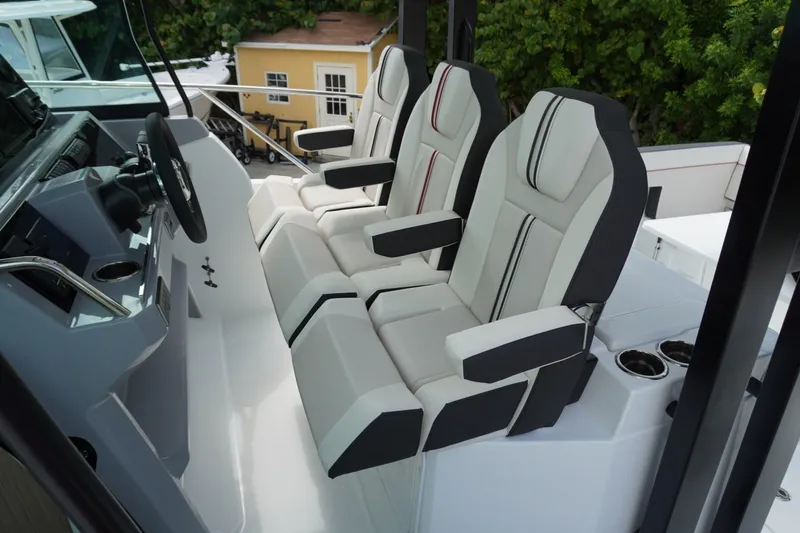 Slide: The Image of 2027 Jeanneau Leader 10.5 WA Series 2 cockpit with modern seating and steering wheel. - 18