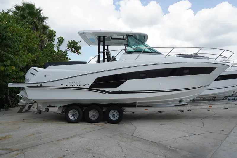Slide: The Image of 2027 Jeanneau Leader 10.5 WA Series 2 boat on trailer, side view. - 1