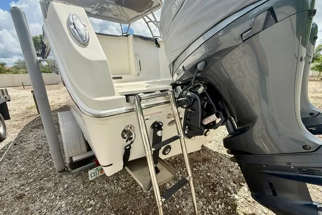 Slide: The Image of 2015 Sailfish 276 DC boat with outboard motor and swim ladder. - 19