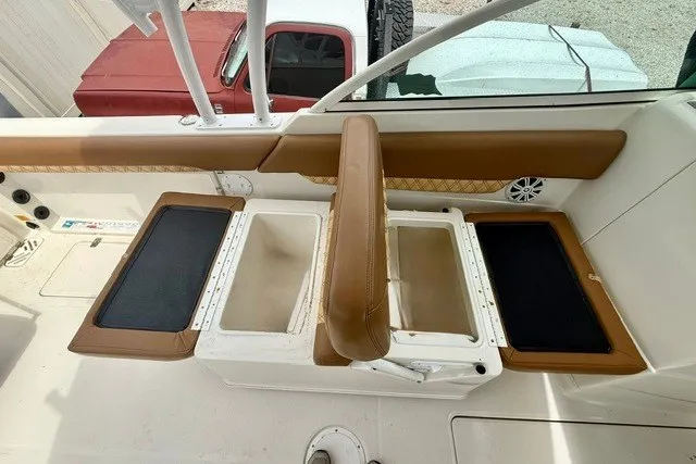 Slide: The Image of 2015 Sailfish 276 DC boat interior with tan seating and storage compartments. - 11