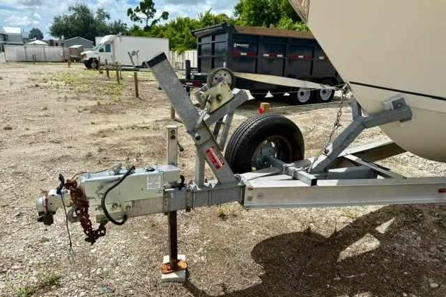 Slide: The Image of Trailer hitch of a 2015 Sailfish 276 DC boat in a gravel lot. - 20