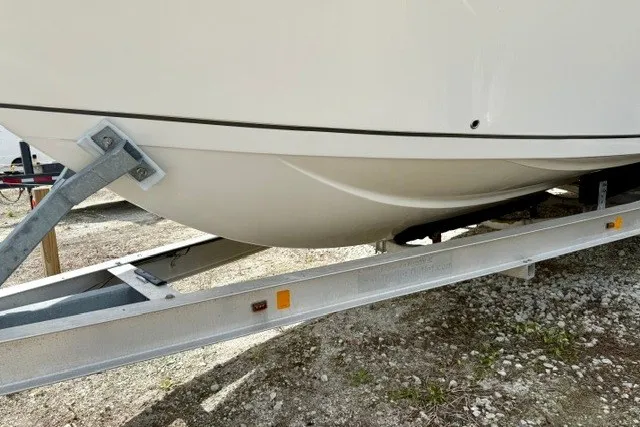 Slide: The Image of 2015 Sailfish 276 DC boat hull on trailer, showcasing sleek design and sturdy construction. - 18