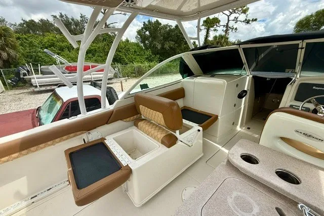 Slide: The Image of 2015 Sailfish 276 DC boat interior with seating, storage, and helm area. - 10