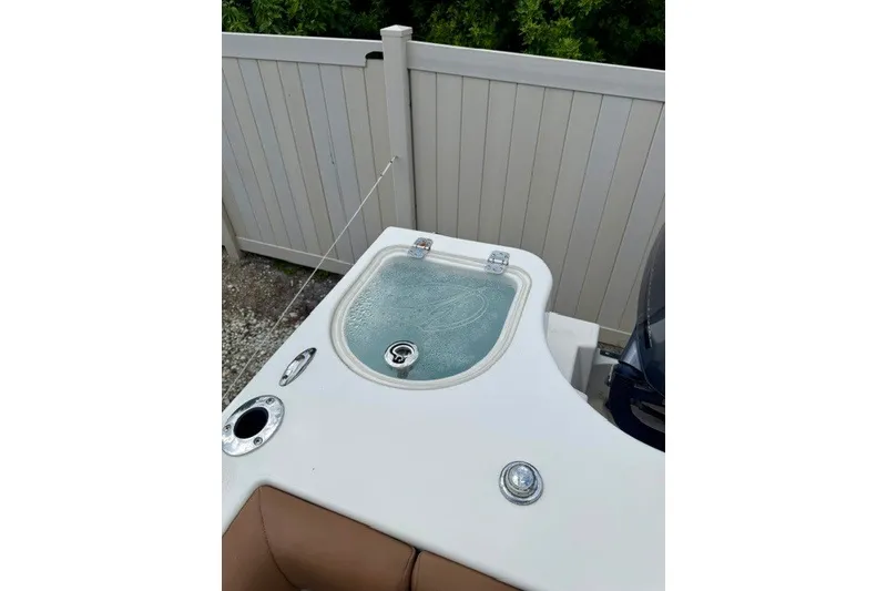 Slide: The Image of 2015 Sailfish 276 DC boat livewell with white deck and seating. - 7