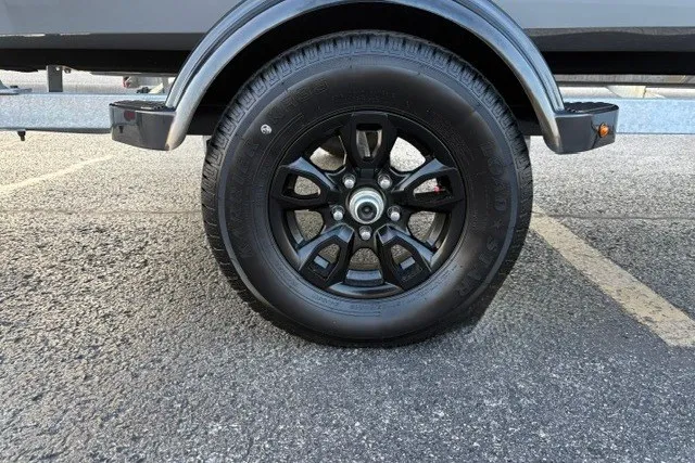 Slide: The Image of Trailer wheel of 2027 Tracker Bass Tracker 175 CC on asphalt. - 33