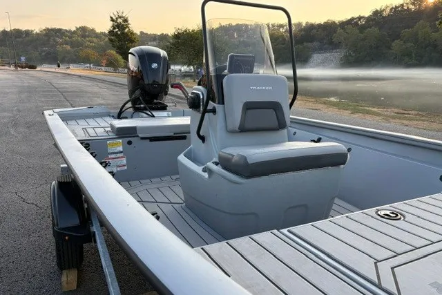 Slide: The Image of 2027 Tracker Bass Tracker 175 CC boat on trailer, parked near a scenic lake. - 24
