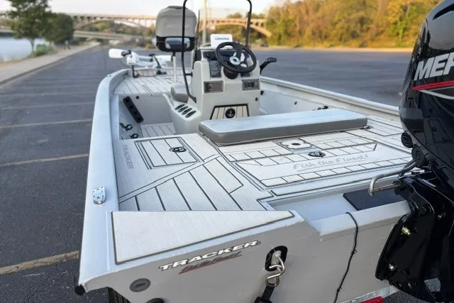 Slide: The Image of 2027 Tracker Bass Tracker 175 CC boat with sleek design, parked near a scenic river. - 19