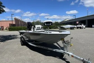 The Image of 2027 Tracker Bass Tracker 175 CC boat on trailer in parking lot under blue sky. - 0