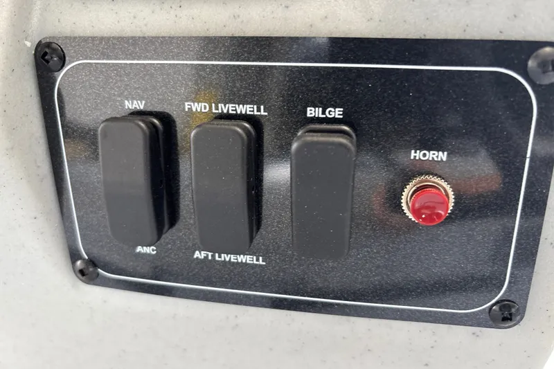 Slide: The Image of Control panel of 2027 Tracker Bass Tracker 175 CC boat with switches and horn button. - 19