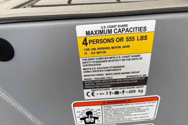 Slide: The Image of 2027 Tracker Bass Tracker 175 CC capacity label, 4 persons or 555 lbs, safety standards. - 31