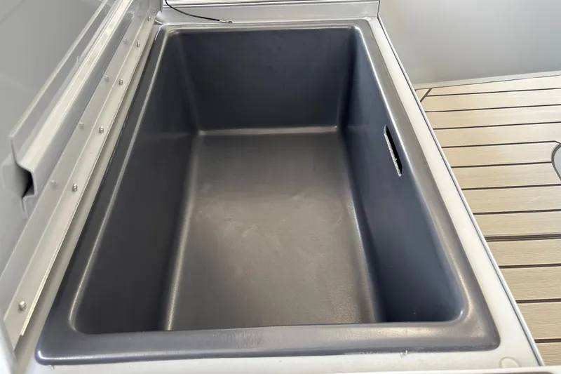 Slide: The Image of Livewell compartment on 2027 Tracker Bass Tracker 175 CC boat, featuring a spacious interior. - 27