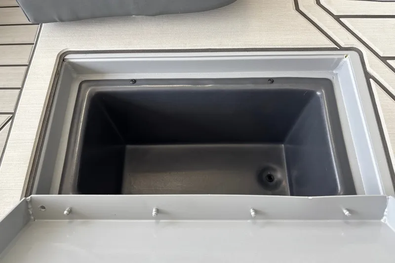 Slide: The Image of 2027 Tracker Bass Tracker 175 CC livewell compartment, open and empty, on boat deck. - 29