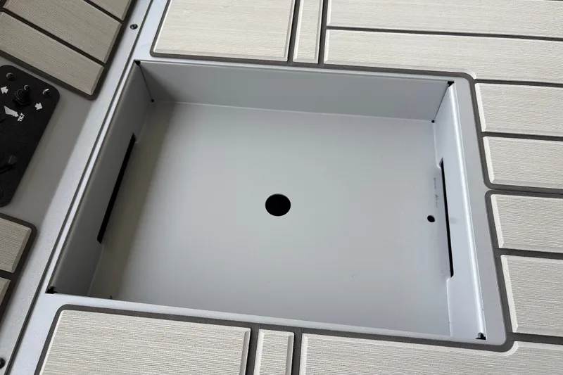 Slide: The Image of 2027 Tracker Bass Tracker 175 CC boat compartment with control panel and textured flooring. - 25