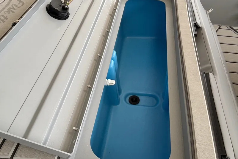 Slide: The Image of 2027 Tracker Bass Tracker 175 CC boat storage compartment with blue interior. - 22