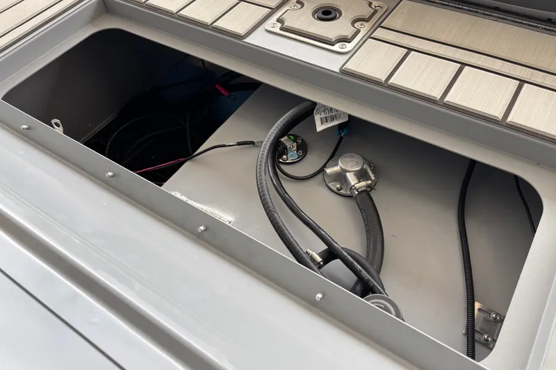 Slide: The Image of Open compartment of 2027 Tracker Bass Tracker 175 CC boat showing internal wiring and components. - 30