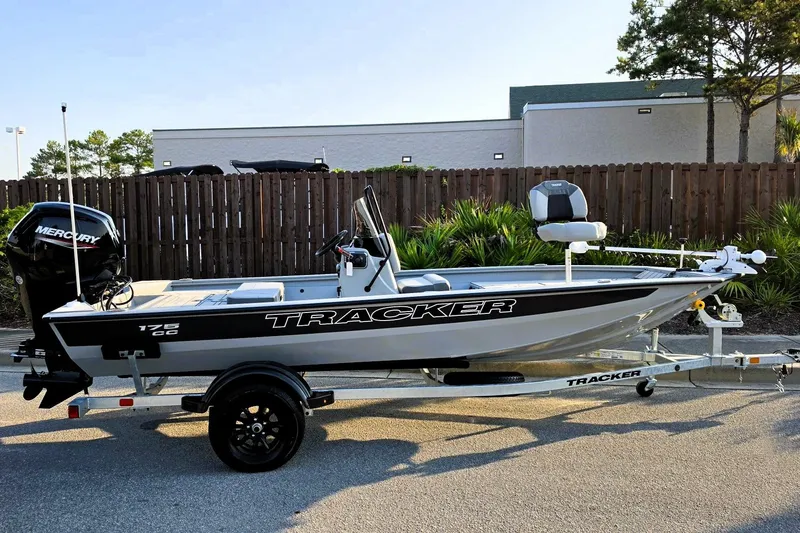 The Image of 2027 Tracker Bass Tracker 175 CC boat on trailer, featuring Mercury engine, parked outdoors. - 0