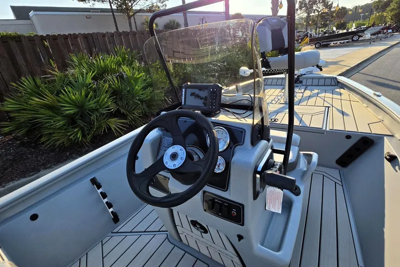 Slide: The Image of 2027 Tracker Bass Tracker 175 CC boat interior with steering wheel and control panel. - 17