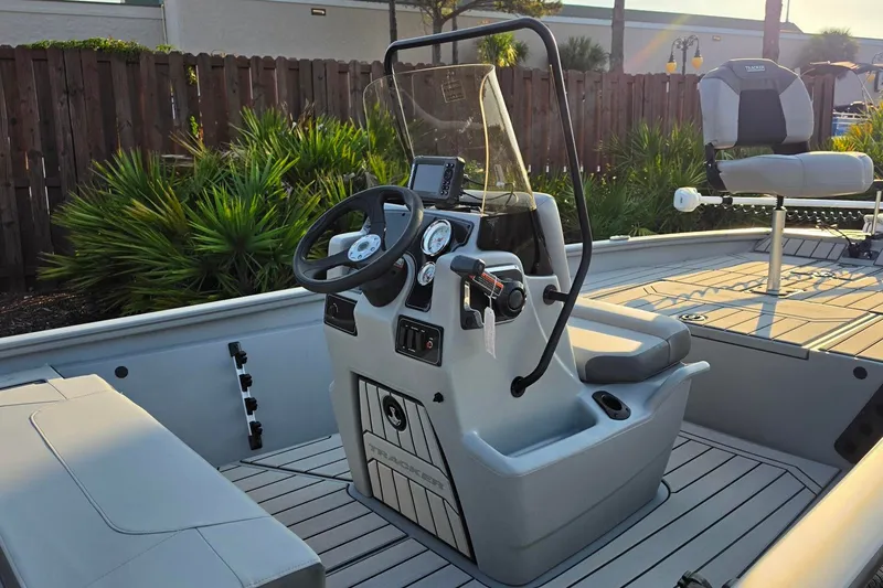 Slide: The Image of 2027 Tracker Bass Tracker 175 CC boat interior with steering console and seating. - 16