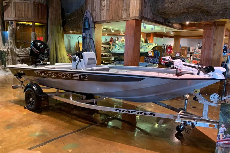 The Image of 2027 Tracker Bass Tracker 175 CC boat displayed indoors on a trailer. - 0