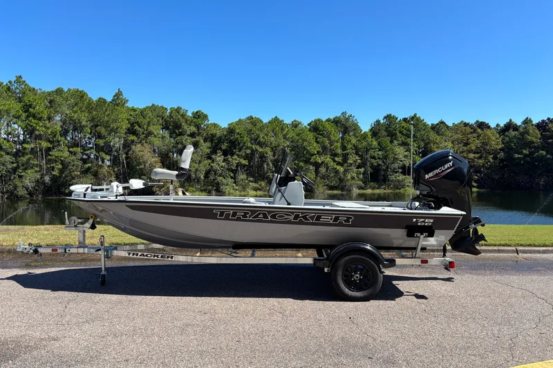 The Image of 2027 Tracker Bass Tracker 175 CC boat on trailer by a scenic lake. - 0