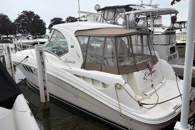 The Image of 2007 Sea Ray 40 Sundancer docked at marina, featuring sleek design and enclosed cockpit. - 0
