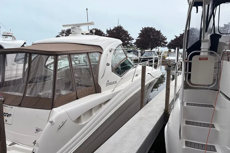 Slide: The Image of 2007 Sea Ray 40 Sundancer yacht docked at marina, featuring sleek design and covered cockpit. - 2