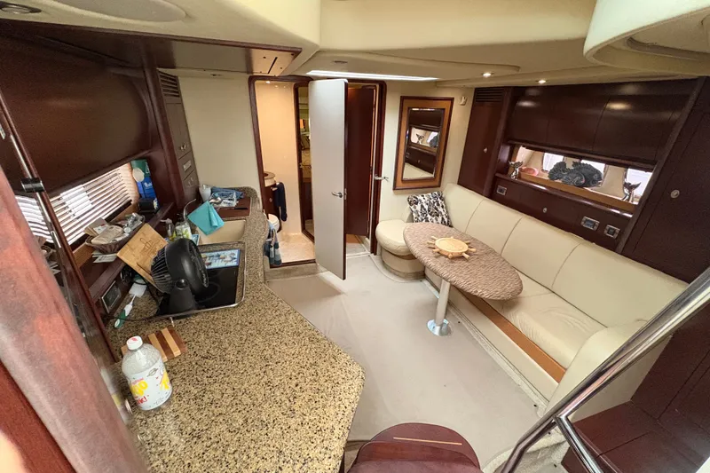Slide: The Image of Interior of 2007 Sea Ray 40 Sundancer yacht with elegant seating and kitchenette. - 24