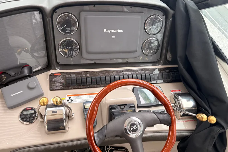 Slide: The Image of Helm of 2007 Sea Ray 40 Sundancer with Raymarine navigation system and wooden steering wheel. - 21