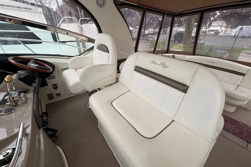Slide: The Image of Interior of a 2007 Sea Ray 40 Sundancer yacht with white seating and helm. - 16