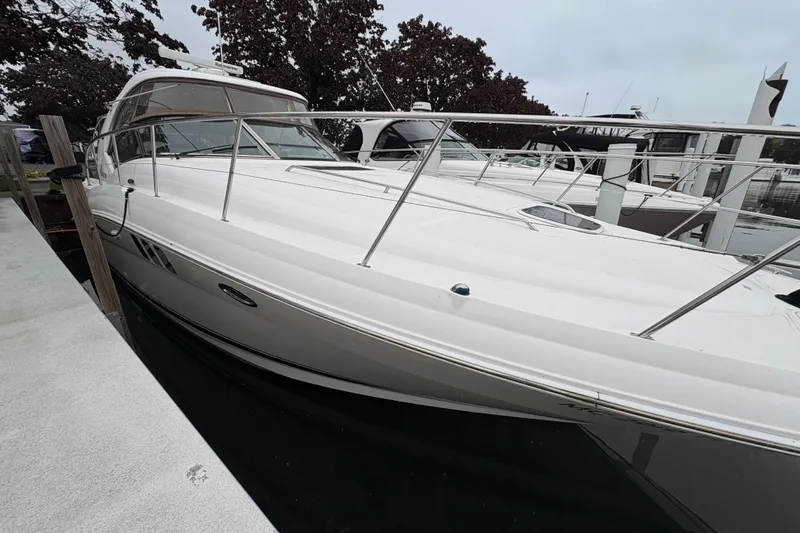 Slide: The Image of 2007 Sea Ray 40 Sundancer yacht docked at marina, showcasing sleek design and white exterior. - 3