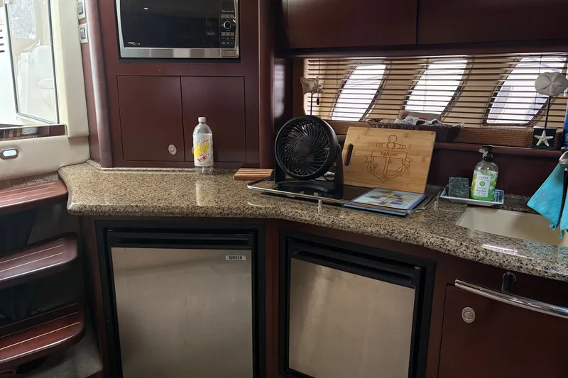 Slide: The Image of Interior of 2007 Sea Ray 40 Sundancer yacht with kitchenette and appliances. - 25