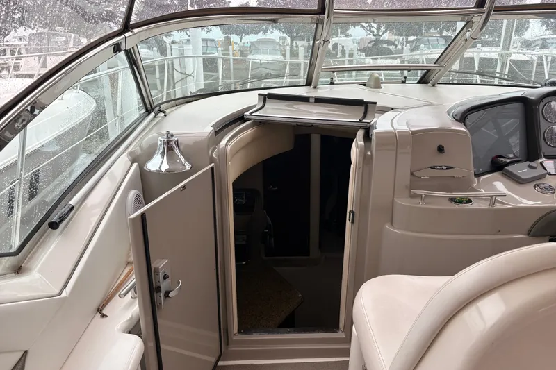 Slide: The Image of 2007 Sea Ray 40 Sundancer cockpit with open cabin door, showcasing helm and seating area. - 17