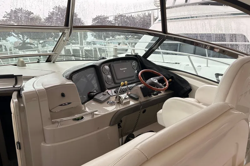 Slide: The Image of Helm of 2007 Sea Ray 40 Sundancer with steering wheel and navigation controls. - 18
