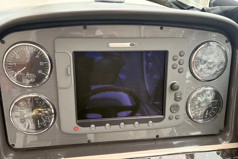 Slide: The Image of Dashboard of a 2007 Sea Ray 40 Sundancer boat with gauges and navigation screen. - 14