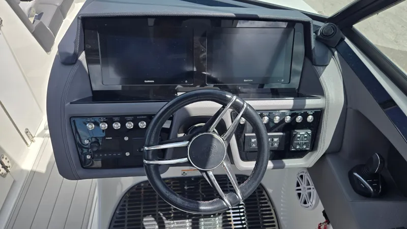 Slide: The Image of The image shows the helm of a Cobalt 30SC boat with modern instruments and a sleek steering wheel. - 2