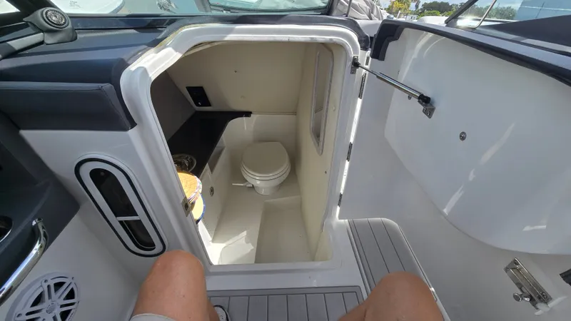 Slide: The Image of The image shows the interior of a boat bathroom with a toilet and a sink. - 7