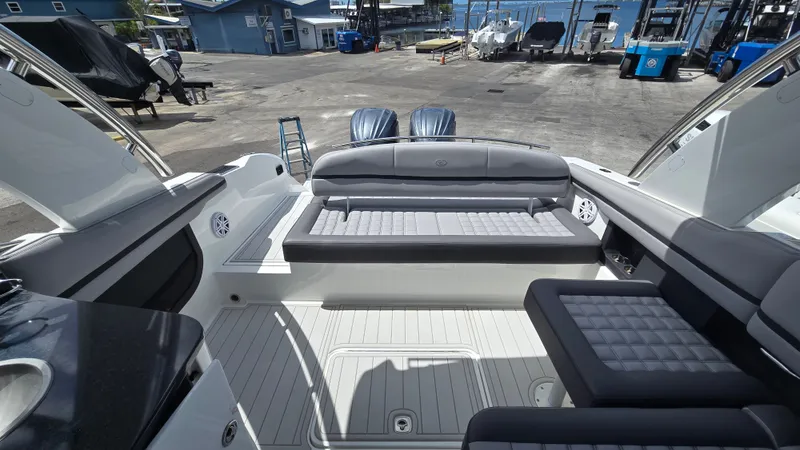 Slide: The Image of The image shows the cockpit of a 2023 Cobalt 30SC boat with gray upholstery. - 10