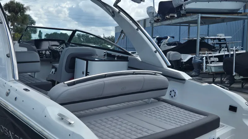 Slide: The Image of The image shows the cockpit of a 2023 Cobalt 30SC boat with gray upholstery. - 12